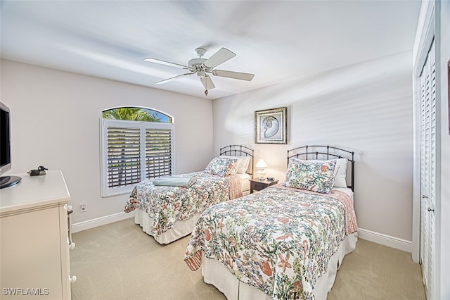 bedroom with light colored carpet and ceiling fan