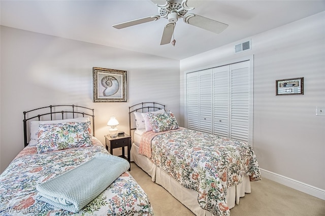 carpeted bedroom featuring a closet and ceiling fan