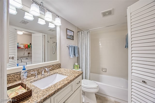 full bathroom with vanity, shower / tub combo, washer and dryer, and toilet