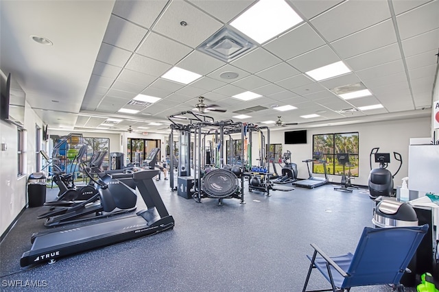 gym featuring a drop ceiling and ceiling fan