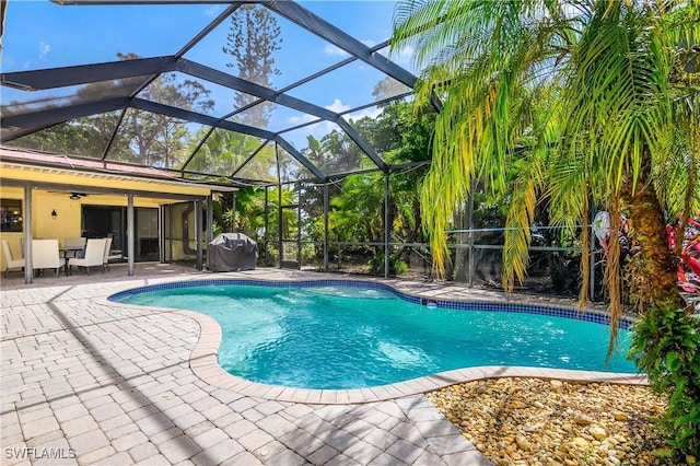 outdoor pool featuring area for grilling, a ceiling fan, and a patio