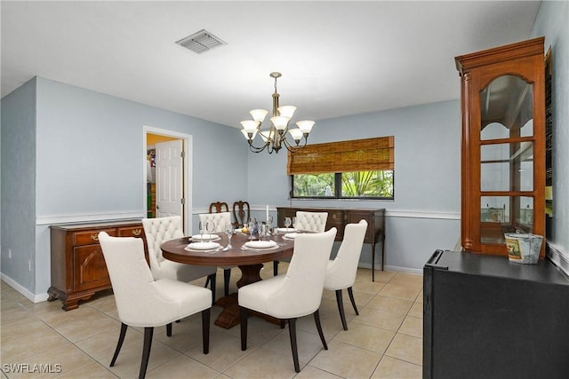 dining space with visible vents, a notable chandelier, baseboards, and light tile patterned floors