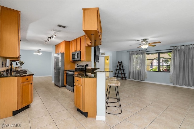 kitchen with stainless steel appliances, visible vents, light tile patterned flooring, a peninsula, and a kitchen breakfast bar