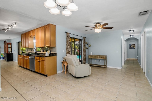 kitchen with dishwasher, light tile patterned flooring, a sink, and visible vents