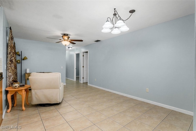 sitting room featuring light tile patterned flooring, visible vents, baseboards, and ceiling fan with notable chandelier