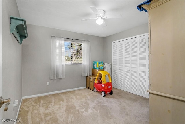 rec room featuring carpet floors, a ceiling fan, and baseboards