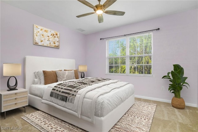 carpeted bedroom with visible vents, ceiling fan, and baseboards