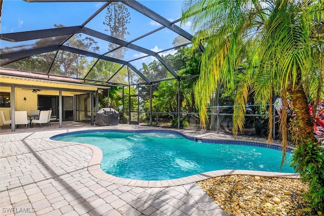 outdoor pool with a patio area, a grill, and a ceiling fan