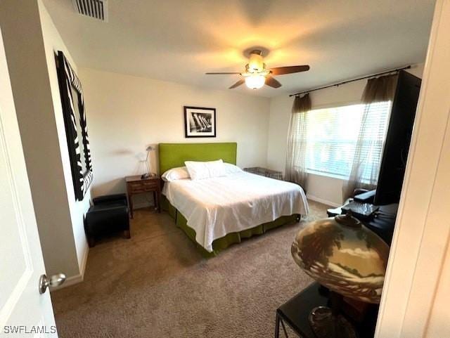 bedroom with dark colored carpet and ceiling fan