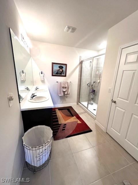 bathroom featuring walk in shower, tile patterned floors, and vanity