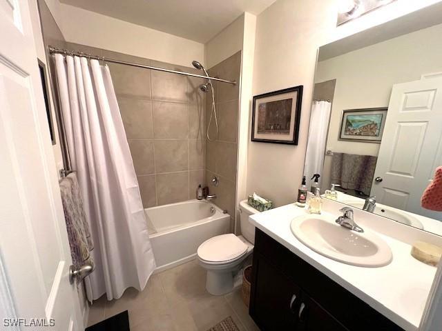 full bathroom with tile patterned flooring, vanity, shower / bathtub combination with curtain, and toilet