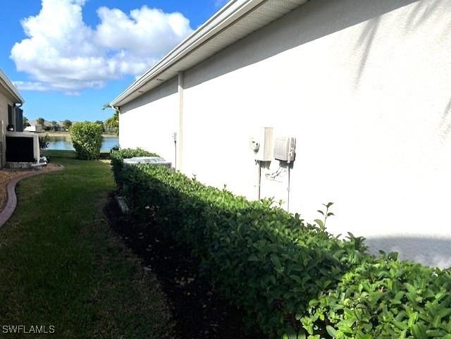 view of side of home featuring a water view