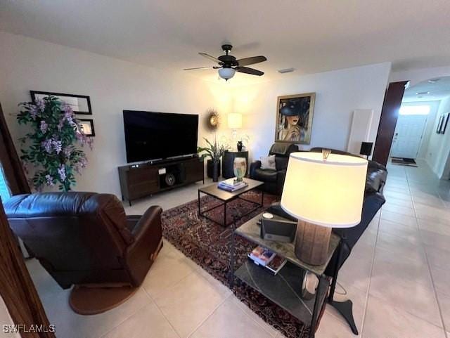 tiled living room with ceiling fan