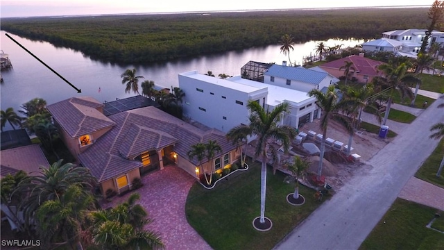 aerial view at dusk with a water view