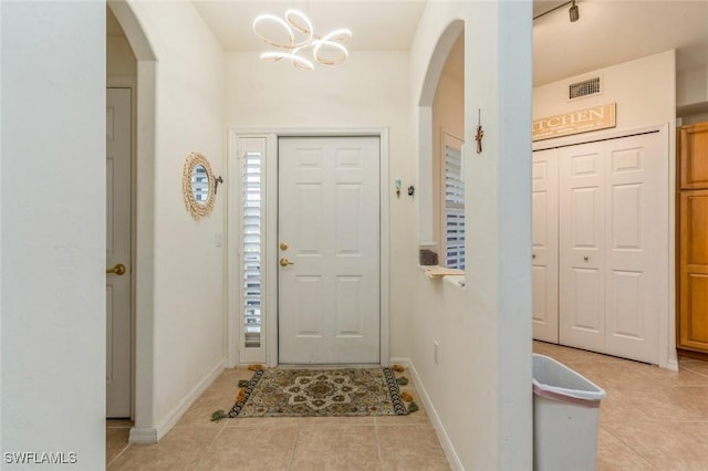 foyer entrance with light tile patterned flooring