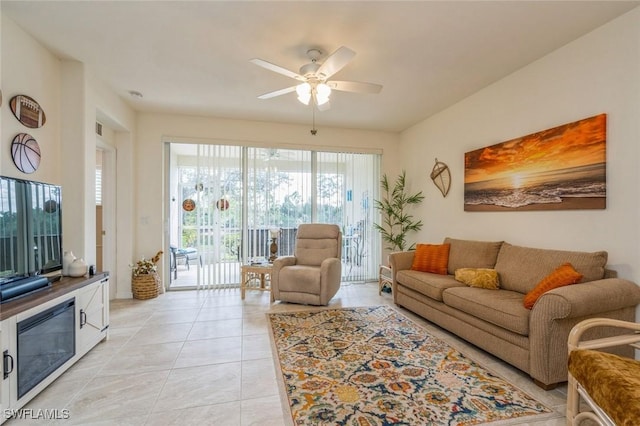 tiled living room featuring ceiling fan