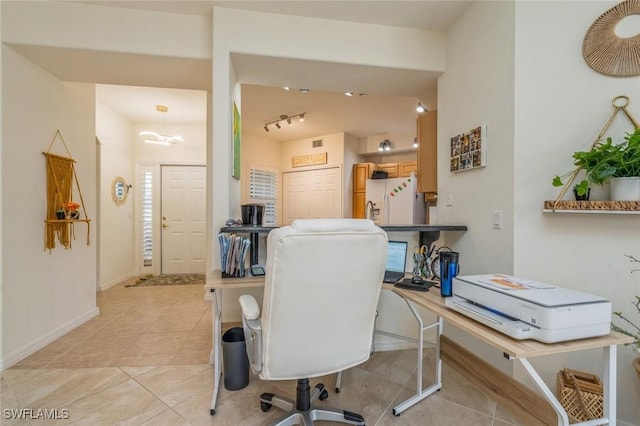 office space featuring light tile patterned floors and track lighting