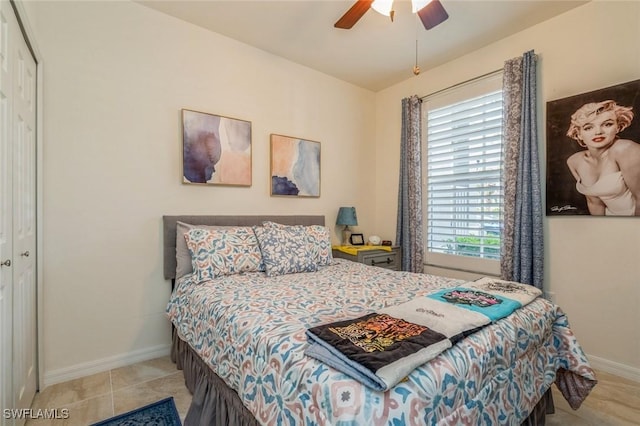 bedroom with light tile patterned floors, a closet, and ceiling fan