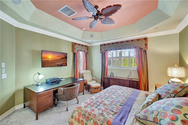 bedroom with ceiling fan, ornamental molding, a tray ceiling, and light carpet