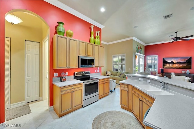 kitchen featuring light tile patterned flooring, sink, crown molding, ceiling fan, and stainless steel appliances