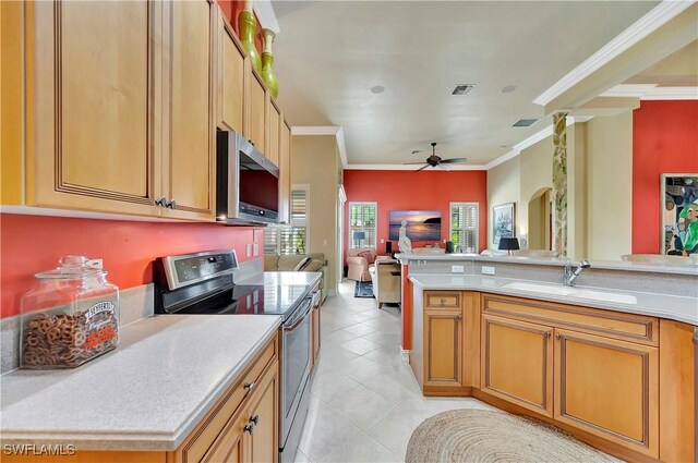 kitchen with sink, crown molding, light tile patterned flooring, and appliances with stainless steel finishes