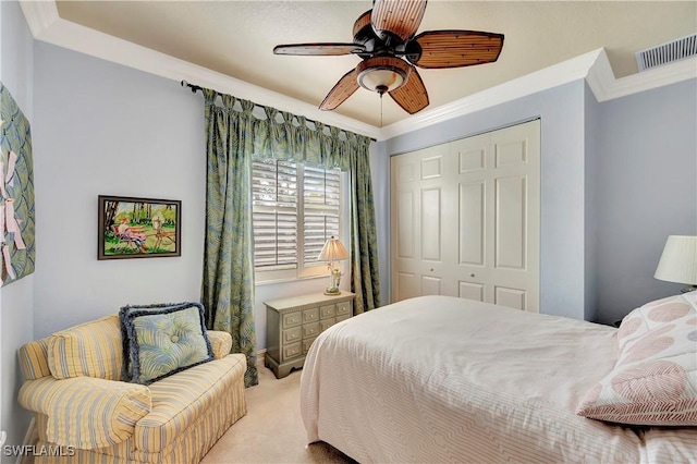 bedroom with ceiling fan, a closet, ornamental molding, and light carpet