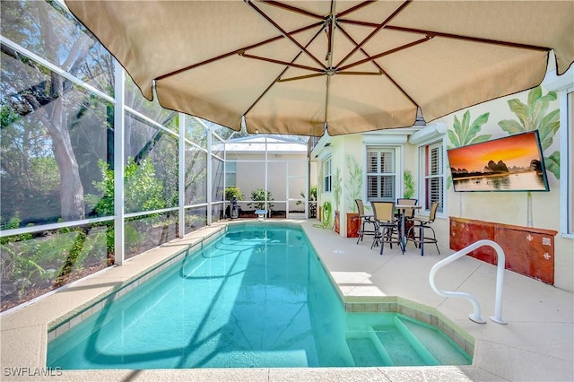 view of swimming pool featuring a patio and glass enclosure