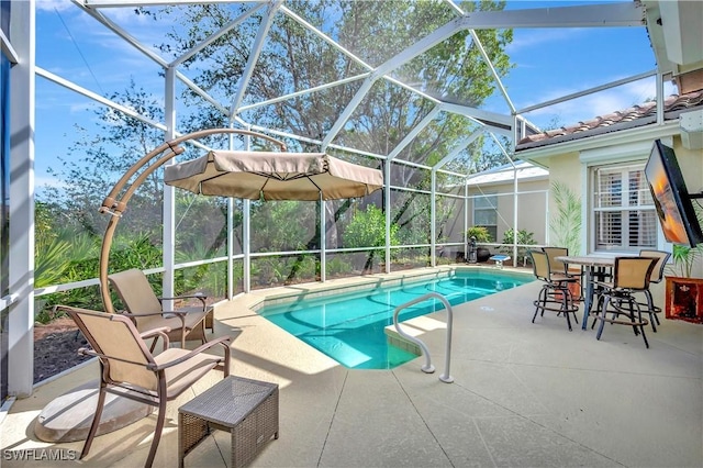 view of swimming pool with a patio and glass enclosure