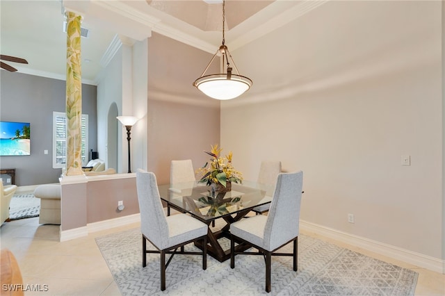 dining room with ornamental molding, baseboards, arched walkways, light tile patterned flooring, and ceiling fan