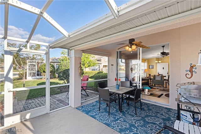 sunroom / solarium featuring ceiling fan