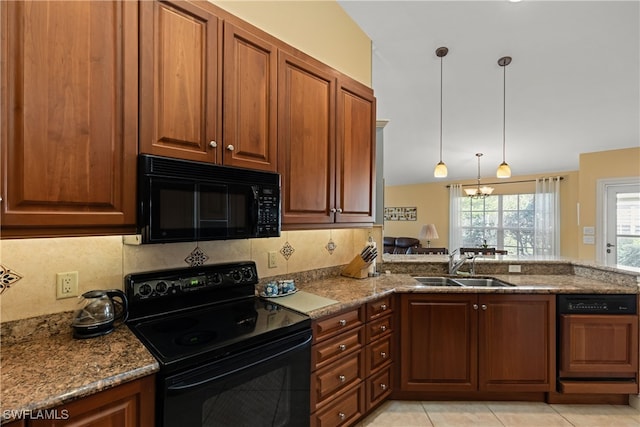 kitchen featuring light stone counters, sink, decorative backsplash, and black appliances