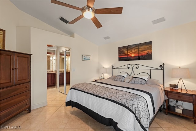 tiled bedroom with lofted ceiling, ensuite bath, and ceiling fan