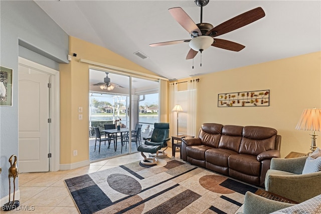 living room featuring lofted ceiling, light tile patterned floors, and ceiling fan