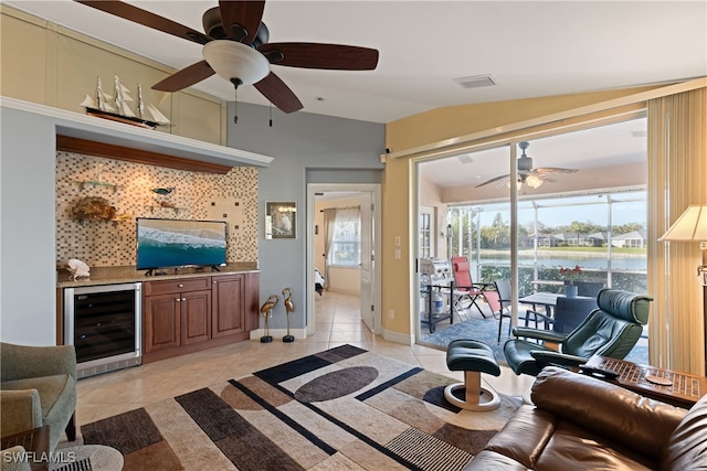 tiled living room featuring wine cooler, vaulted ceiling, and ceiling fan