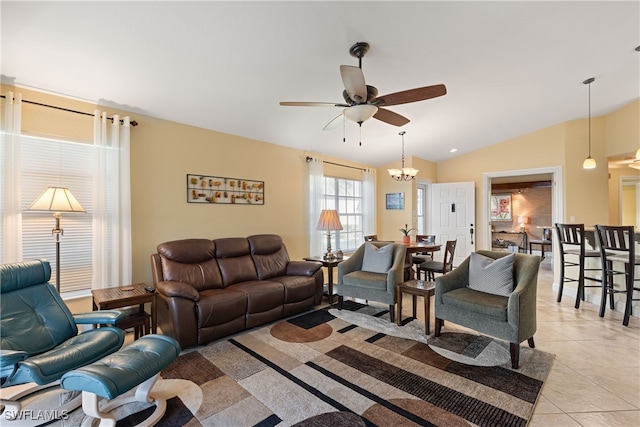 living room featuring light tile patterned floors, ceiling fan with notable chandelier, and vaulted ceiling