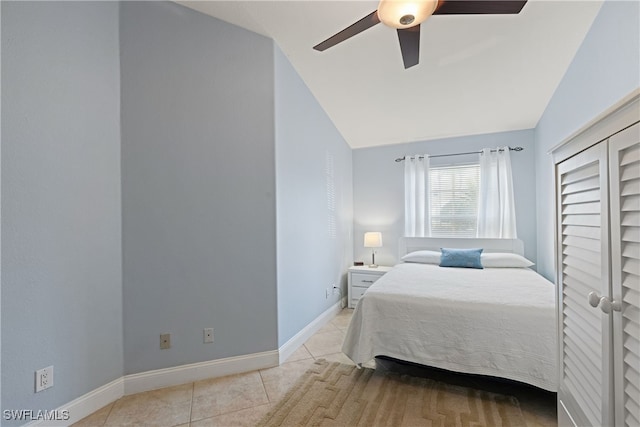 tiled bedroom featuring lofted ceiling and ceiling fan