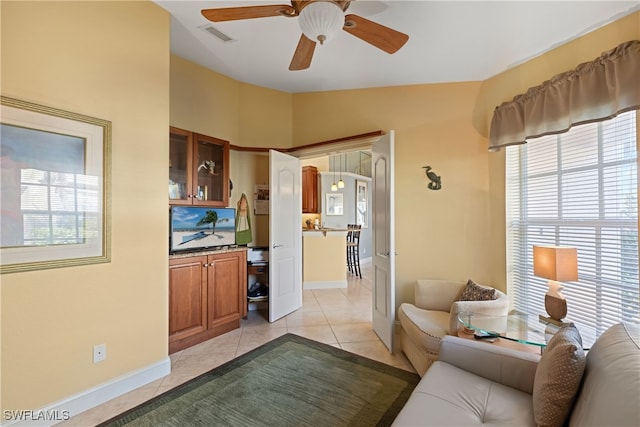 tiled living room featuring vaulted ceiling and ceiling fan