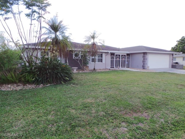 ranch-style home featuring a garage and a front lawn