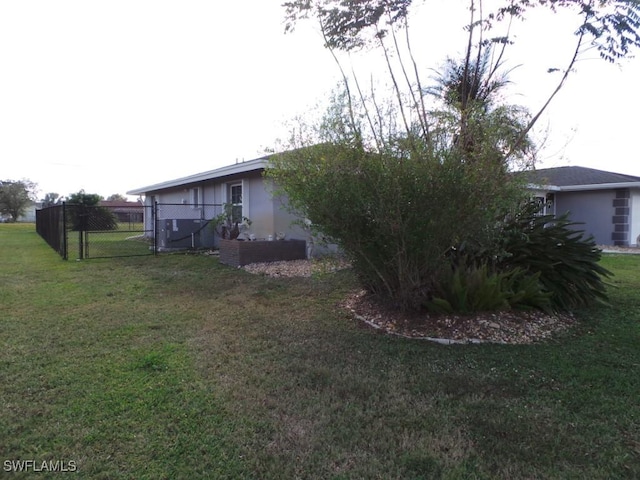 view of side of property with a yard