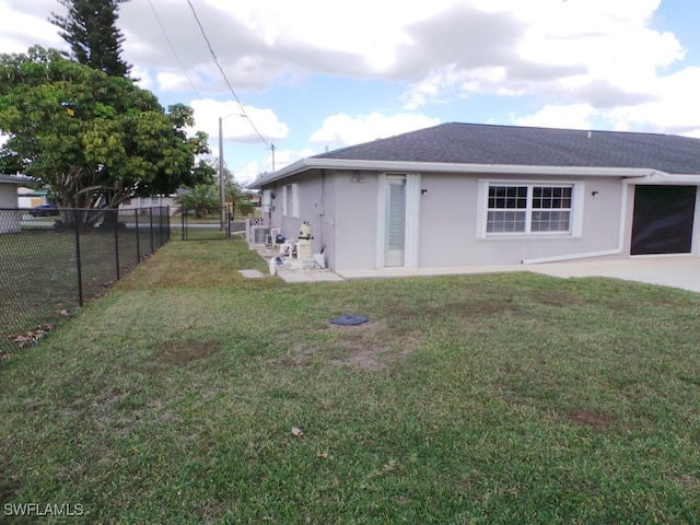 rear view of property featuring a yard and a patio