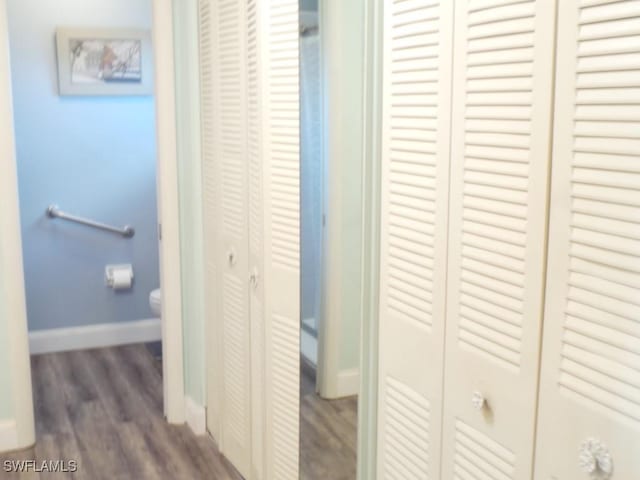 corridor with dark hardwood / wood-style flooring