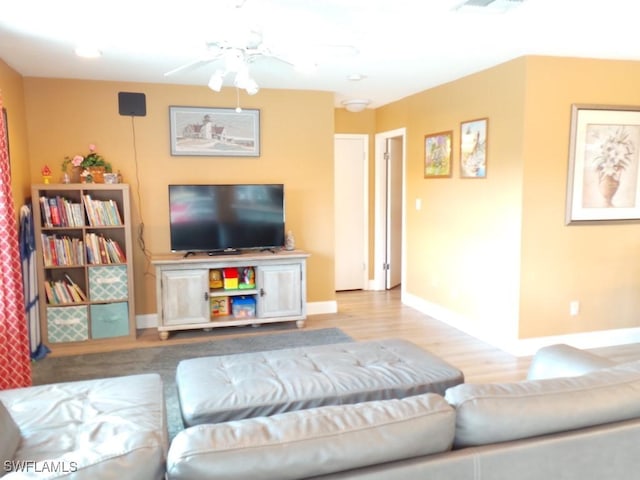 living room with ceiling fan and light wood-type flooring