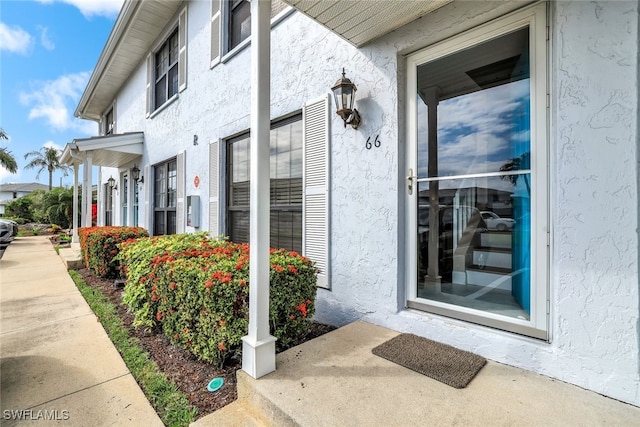 view of exterior entry with stucco siding