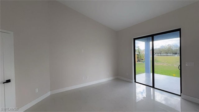 unfurnished room with baseboards and vaulted ceiling