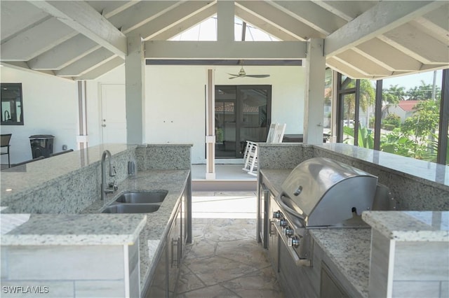 view of patio featuring ceiling fan, a gazebo, an outdoor wet bar, area for grilling, and an outdoor kitchen