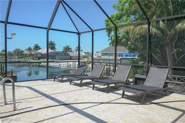 view of patio / terrace featuring a lanai and a water view