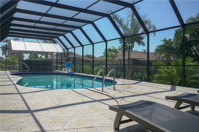 view of swimming pool featuring a lanai and a patio