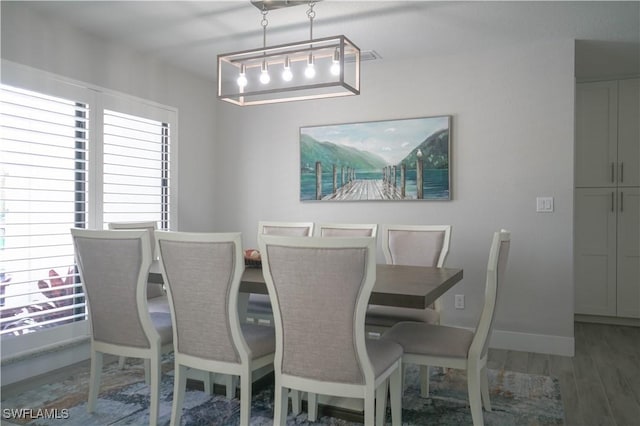 dining area with wood-type flooring