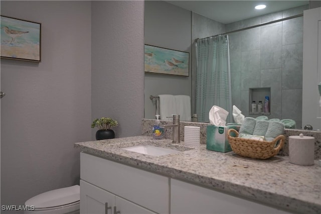 bathroom with vanity, a shower with curtain, and toilet