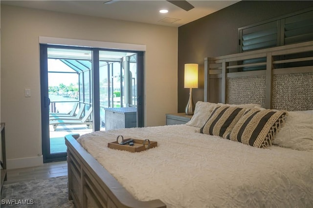 bedroom with dark hardwood / wood-style floors, ceiling fan, and access to exterior